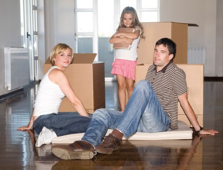 Local removals team loading furniture into a moving van